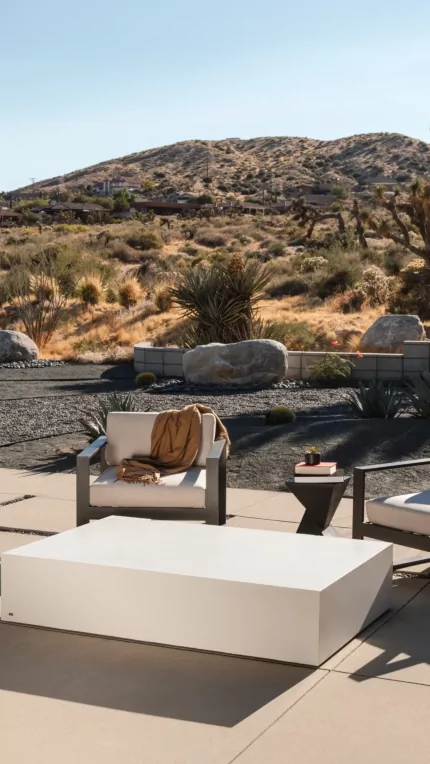 Blinde Design Move 65 Coffee Table in bone concrete anchors Starfire garden patio, delivering modern outdoor coffee table focal point.