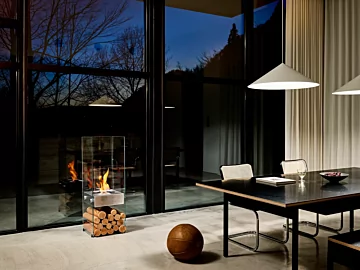 EcoSmart Fire Ghost Designer Fireplace brings modern ethanol heating to a private residence dining room in Japan with a sleek freestanding design.